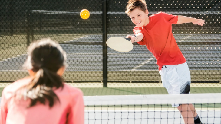 Kids playing on a tennis court